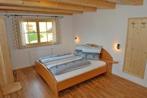 a bedroom with a wooden bed in a room at Ferienhaus Johanna in Schladming