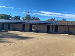 a building with solar panels on the roof at Peppercorn motor inn in Narromine