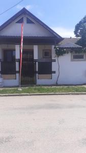 a white house with a flag in front of it at Casa Ana in Eforie Sud
