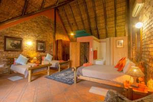 a bedroom with two beds in a room at SERENITY Du Bois Lodge in Marloth Park