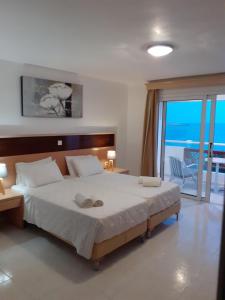 Postel nebo postele na pokoji v ubytování MINOS BEACH KARPATHoS