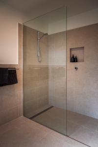 a shower with a glass door in a bathroom at Basedow Haus in Tanunda