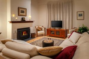 a living room with a couch and a fireplace at Basedow Haus in Tanunda