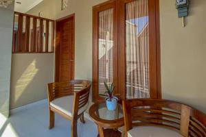 a room with two chairs and a table and a window at RedDoorz near Mertasari Beach 2 in Pesanggaran