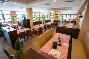 an empty restaurant with tables and chairs and tablesktop at Penzion Toscana in Nitra