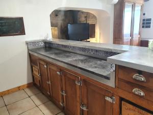 a kitchen with a counter with a tv on it at gite du cresponnet in Murat