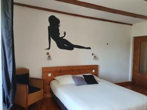 a bedroom with a mermaid sticker on the wall at gite du cresponnet in Murat