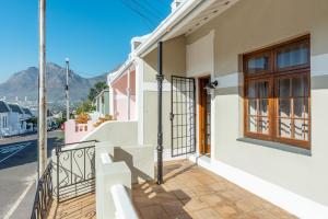 a house with a balcony with a view of a street at Spacious Gem, Outdoor Space, Close to TBMTN&City in Cape Town