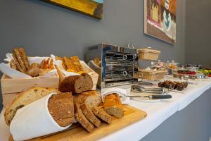 a table topped with bread and other bread items at The Rif - Boutique Hotel in Pisa