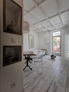 a living room with a table and a dog on the floor at Jardin Vieux Port Panier in Marseille