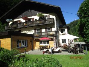 a large house with a balcony and a patio at Haus Chorinskyklause in Bad Goisern