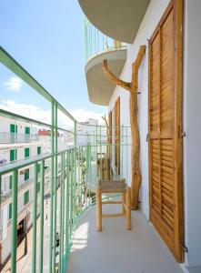 - un balcon avec une chaise dans un bâtiment dans l'établissement Rita Hostal Boutique, à Sant Antoni de Portmany