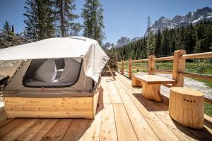a tent sitting on top of a wooden deck at Caravan Park Sexten in Sesto