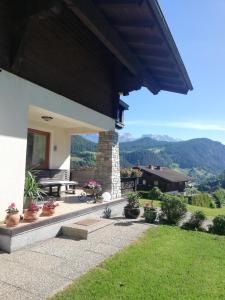 a porch of a house with a view of the mountains at Haus Barbara in Forstau