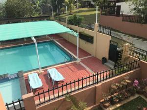 an overhead view of a swimming pool with two chairs at Felicitas Tagaytay in Tagaytay