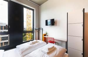 Cama ou camas em um quarto em MEININGER Hotel Genève Centre Charmilles