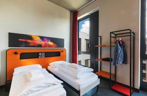 Cama ou camas em um quarto em MEININGER Hotel Genève Centre Charmilles