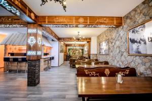 a restaurant with tables and chairs and a bar at Czarna Turnia -ZAKOPANE in Zakopane