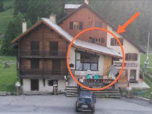 a house with an orange circle in front of it at Appt 211 Taoures Copropriété SucBlanc in Molines-en-Queyras