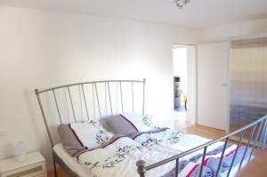 a bed sitting in a room with a railing at Wohnung mit Kamin Terrasse und Grill in der Nähe von Nürnberg in Burgthann