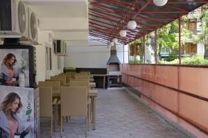 an empty restaurant with tables and chairs and windows at Vila Iunona in Costinesti