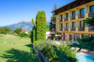a hotel with a view of a garden and a building at VTF Les Balcons du Sauze in Le Sauze +20 photos