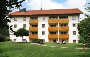 a large white building with a red roof at App.-Haus zur Europa-Therme in Bad Füssing