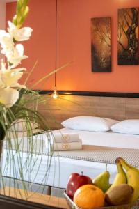 a glass shelf with fruit in front of a bed at Villa Nickolas in Paleo Tsifliki