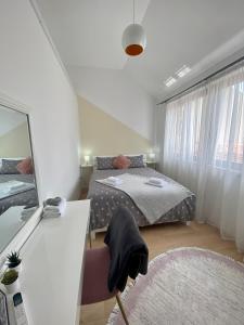 a small bedroom with a bed and a mirror at Dream Apartments in Mostar