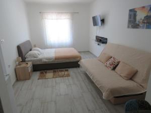 a living room with a couch and a bed at Apartments Jovanović in Perast