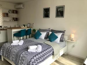 a bedroom with a bed with blue and white pillows at Dream Apartments in Mostar
