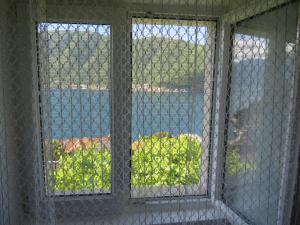 an open window with a view of the water at Apartments Jovanović in Perast