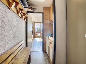 a hallway with a door to a kitchen with a sink at Résidence Lac du Lou - Les Ménuires in Les Menuires