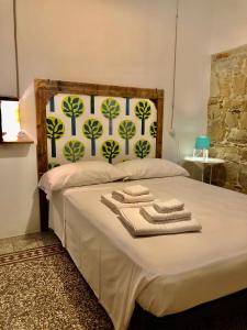a bedroom with a bed with towels on it at Casa della Lampara in Capo dʼOrlando