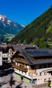 a group of buildings with mountains in the background at Hotel-Garni Pramstraller in Mayrhofen