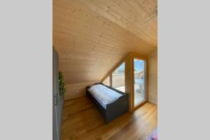 a bedroom in a tiny house with a window at Rosenhaus 1 in Schwarzenberg