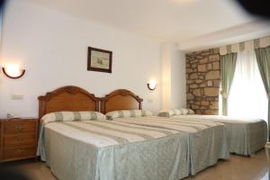 Postel nebo postele na pokoji v ubytování Hotel El Tilo