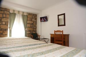 Postel nebo postele na pokoji v ubytování Hotel El Tilo