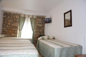 Postel nebo postele na pokoji v ubytování Hotel El Tilo
