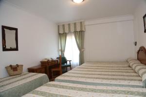 Postel nebo postele na pokoji v ubytování Hotel El Tilo