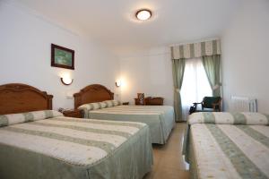 Postel nebo postele na pokoji v ubytování Hotel El Tilo