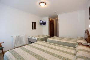 Postel nebo postele na pokoji v ubytování Hotel El Tilo