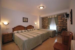 Postel nebo postele na pokoji v ubytování Hotel El Tilo