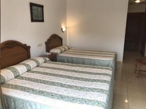 Postel nebo postele na pokoji v ubytování Hotel El Tilo