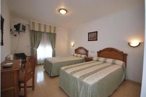 Postel nebo postele na pokoji v ubytování Hotel El Tilo