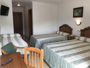 Postel nebo postele na pokoji v ubytování Hotel El Tilo