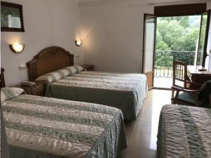 Postel nebo postele na pokoji v ubytování Hotel El Tilo