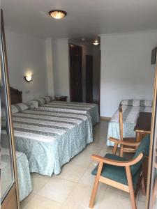 Postel nebo postele na pokoji v ubytování Hotel El Tilo