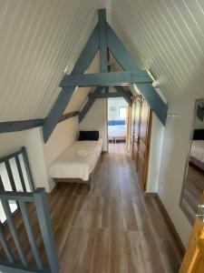 a attic room with a couch and a bed at Cottage Lucas in Rue