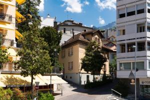 a building in the middle of a city at The Studios Montreux - Swiss Hotel Apartments in Montreux